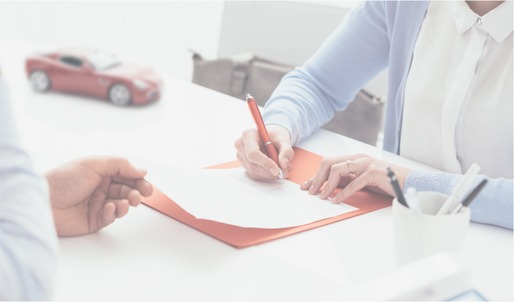 insurance attorney signing paperwork with a client